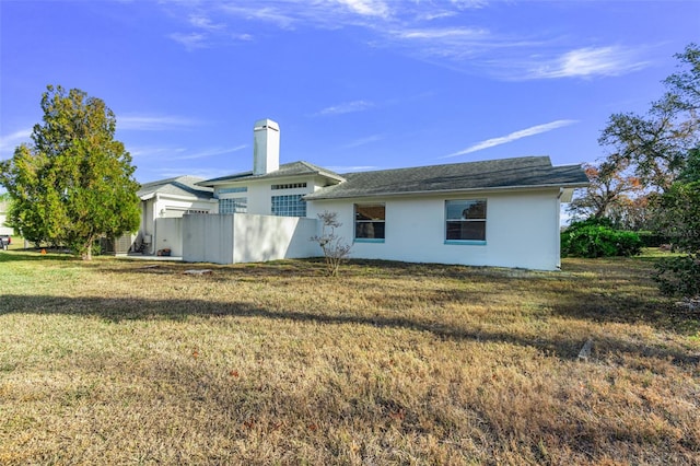 rear view of property with a lawn