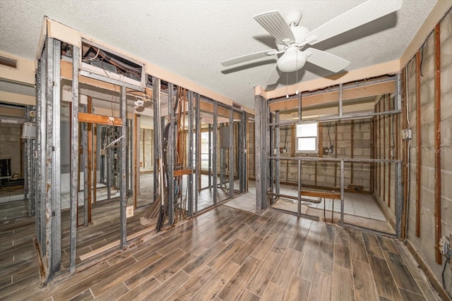 miscellaneous room featuring a textured ceiling and ceiling fan