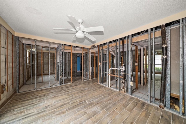 miscellaneous room featuring ceiling fan and a textured ceiling