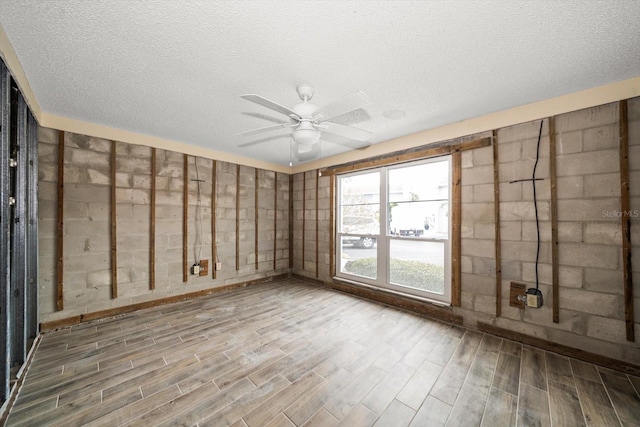 unfurnished room featuring ceiling fan and a textured ceiling