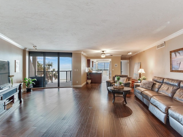 living room featuring floor to ceiling windows, ceiling fan, dark wood-type flooring, a textured ceiling, and ornamental molding