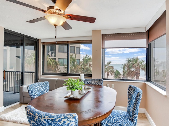 sunroom featuring ceiling fan