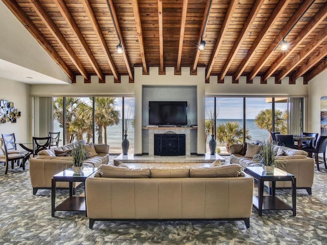 living room with track lighting, wood ceiling, dark colored carpet, high vaulted ceiling, and beam ceiling