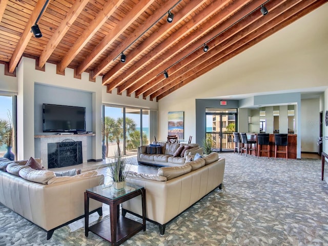 carpeted living room featuring high vaulted ceiling, beamed ceiling, and wood ceiling