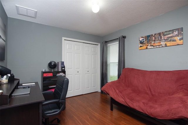 office area featuring a textured ceiling and dark hardwood / wood-style floors