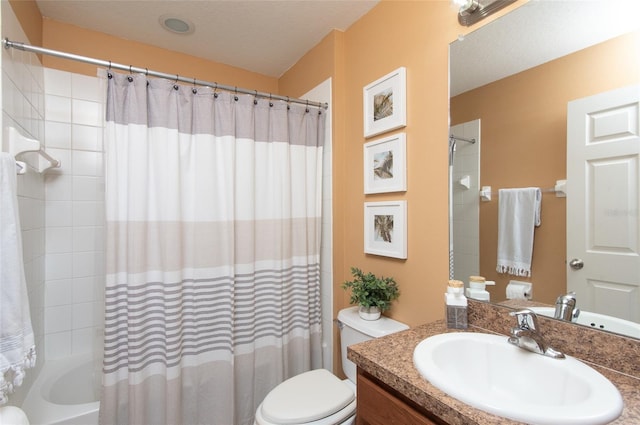 full bathroom featuring toilet, shower / tub combo, vanity, and a textured ceiling