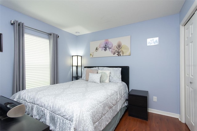 bedroom featuring dark hardwood / wood-style flooring and a closet