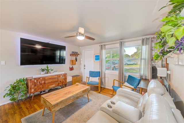 living room with wood-type flooring and ceiling fan