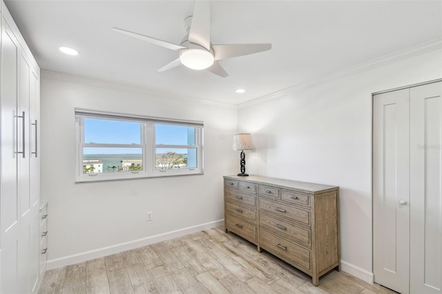 bedroom featuring a ceiling fan, light wood-type flooring, crown molding, and baseboards