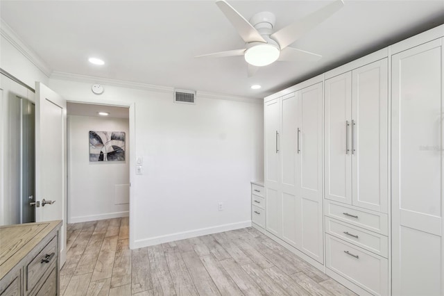 unfurnished bedroom with light wood-style floors, baseboards, visible vents, and crown molding