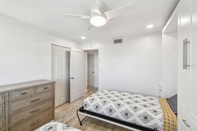 bedroom featuring recessed lighting, a closet, visible vents, ornamental molding, and light wood-type flooring