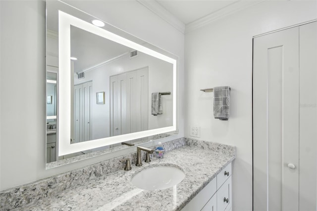 bathroom featuring vanity, visible vents, and crown molding