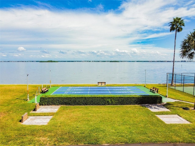 view of community featuring shuffleboard, a yard, and a water view