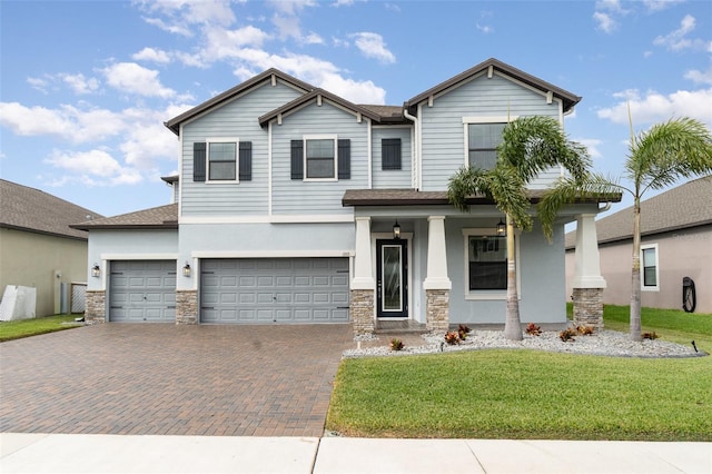 view of front of house featuring a front lawn and a garage