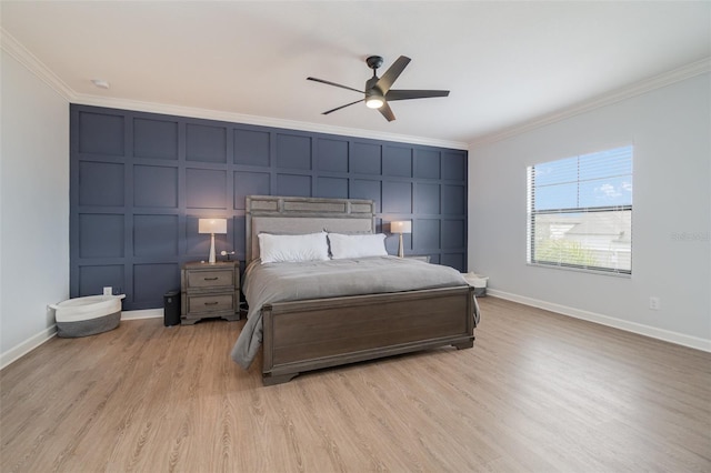 bedroom featuring ceiling fan, light hardwood / wood-style floors, and crown molding