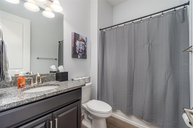 full bathroom featuring toilet, shower / bath combination with curtain, hardwood / wood-style floors, and vanity