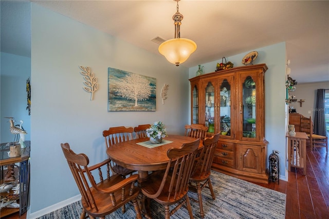 dining space featuring dark hardwood / wood-style floors