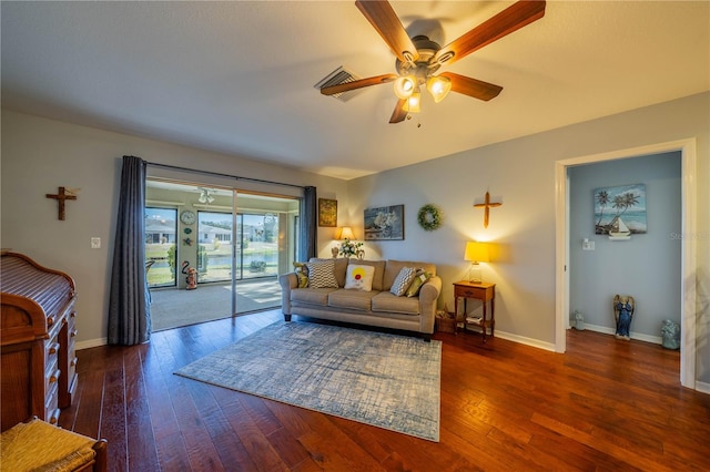 living room with ceiling fan and dark hardwood / wood-style flooring