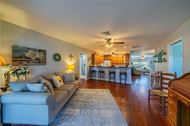 living room with dark hardwood / wood-style floors and ceiling fan