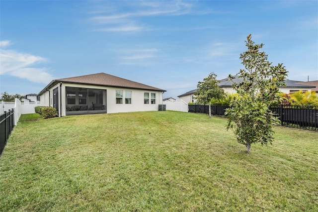 back of house with a lawn and a sunroom