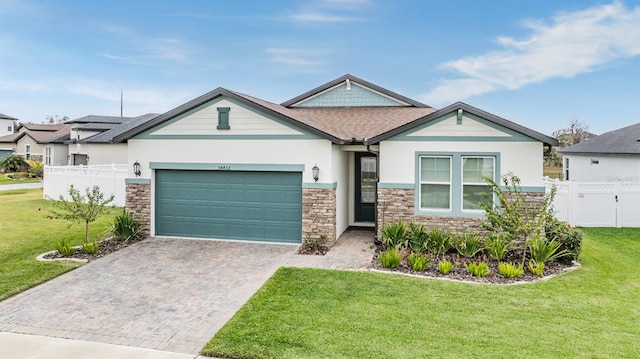 34432 Wynthorne Pl, Wesley Chapel, FL 33545 - view of front of home with stone siding, decorative driveway, a garage, stucco siding, and a shingled roof