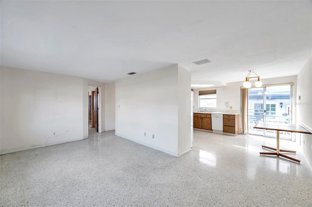 unfurnished living room featuring sink