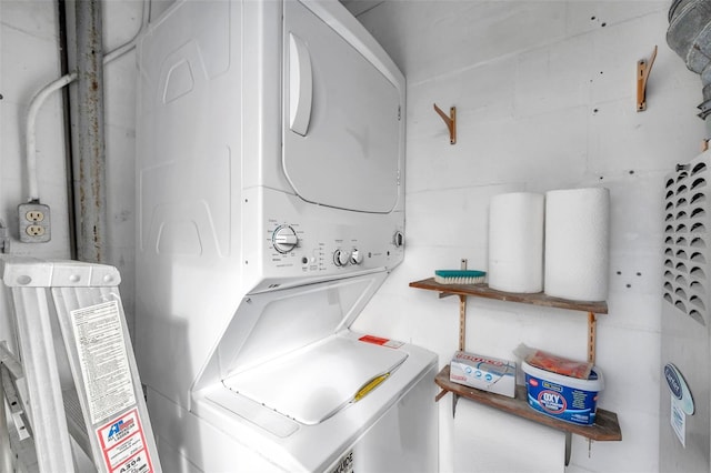 washroom with stacked washer and clothes dryer