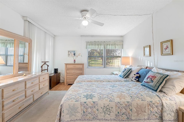 bedroom with a textured ceiling and ceiling fan