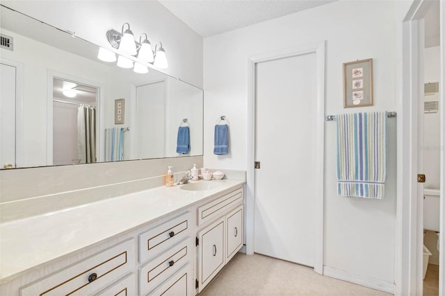 bathroom featuring a textured ceiling, a shower with shower curtain, tile patterned flooring, and vanity