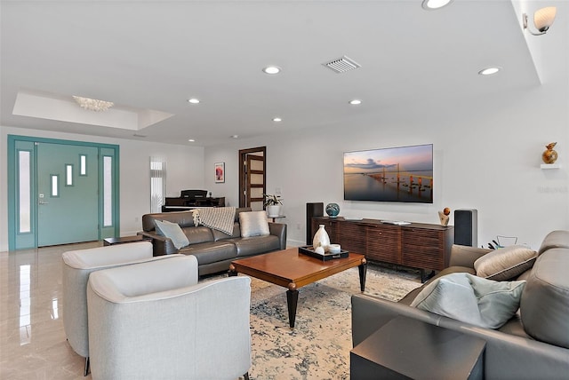 living room featuring a tray ceiling