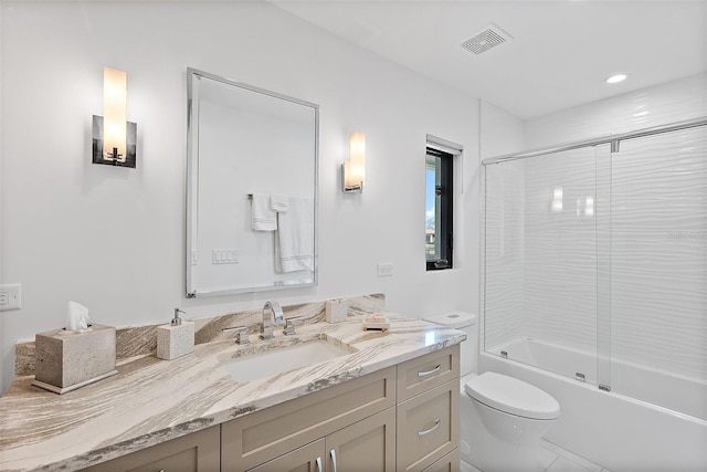 full bathroom with toilet, bath / shower combo with glass door, and vanity