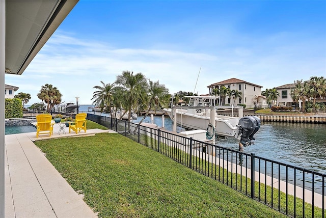 dock area featuring a lawn and a water view