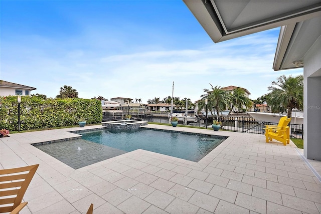 view of swimming pool featuring a water view, a patio area, and an in ground hot tub