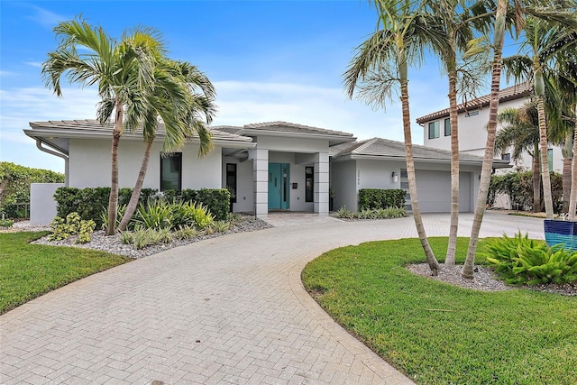 view of front facade featuring a front yard and a garage