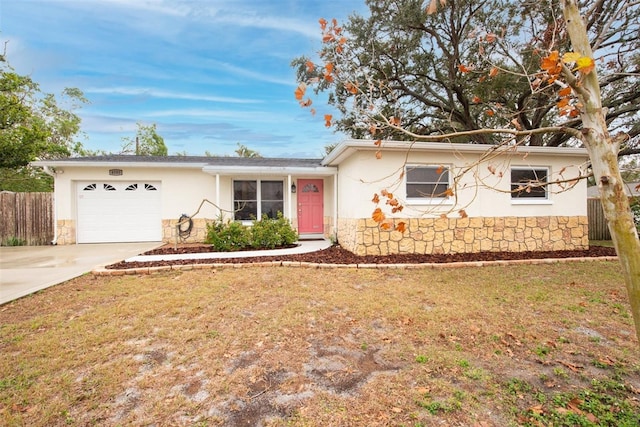 ranch-style home with a garage and a front yard