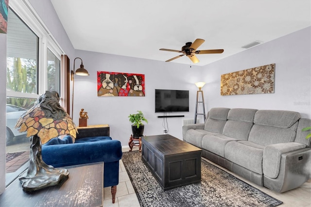 tiled living room featuring ceiling fan