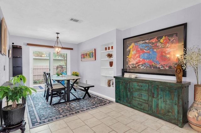 dining area with built in shelves and light tile patterned flooring