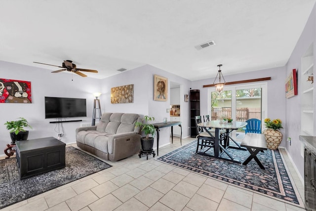 tiled living room featuring ceiling fan