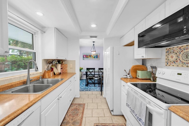 kitchen featuring a raised ceiling, sink, white cabinets, and white appliances