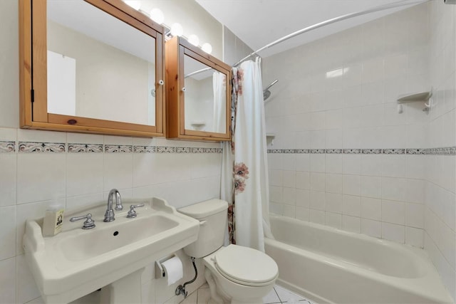 full bathroom featuring sink, tile walls, shower / tub combo with curtain, and toilet