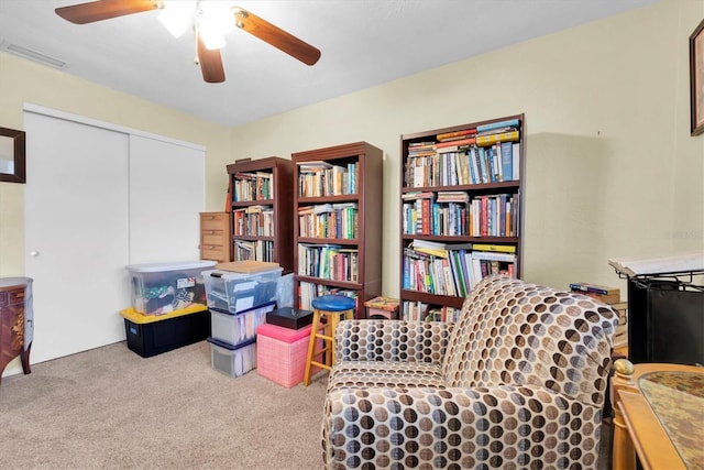 sitting room featuring light carpet