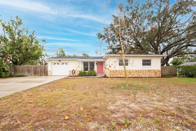 ranch-style house featuring a garage and a front lawn