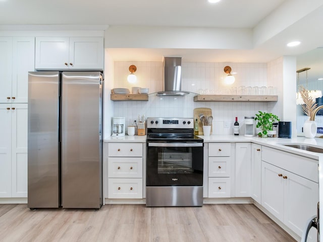 kitchen featuring tasteful backsplash, white cabinetry, ventilation hood, and appliances with stainless steel finishes