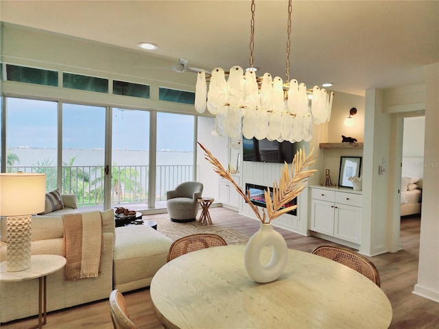 dining space featuring wood-type flooring and a notable chandelier