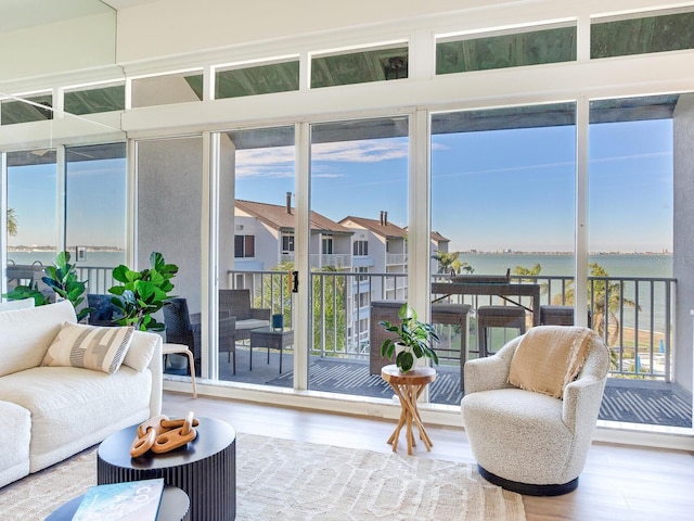 sunroom / solarium featuring a water view