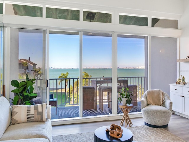 sunroom / solarium featuring a water view