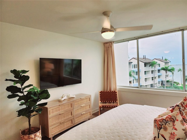 bedroom with multiple windows and ceiling fan