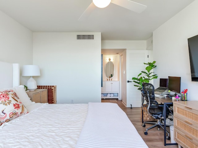 bedroom featuring hardwood / wood-style flooring, ceiling fan, and ensuite bathroom