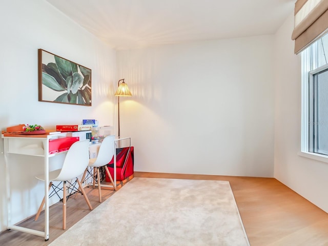 home office with hardwood / wood-style flooring and plenty of natural light