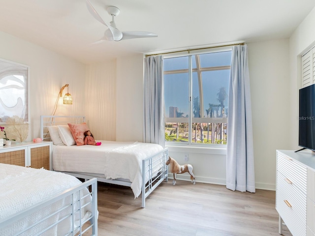 bedroom with ceiling fan and light hardwood / wood-style flooring